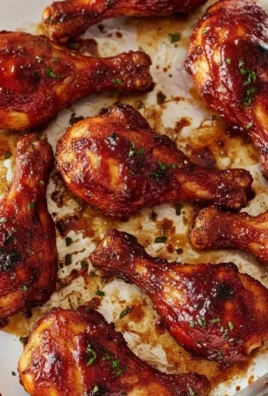 Baked BBQ Chicken Drumsticks on a serving platter with barbecue sauce