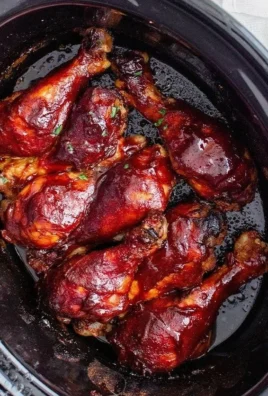 Grilled BBQ chicken drumsticks served on a platter with barbecue sauce.