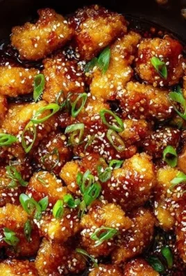 Plate of crispy Chinese honey garlic chicken with garnishes