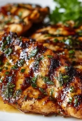 Plate of easy grilled chicken garnished with herbs and served with vegetables