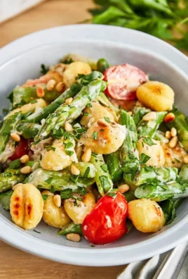 Gnocchi dish with fresh asparagus and cherry tomatoes on a plate