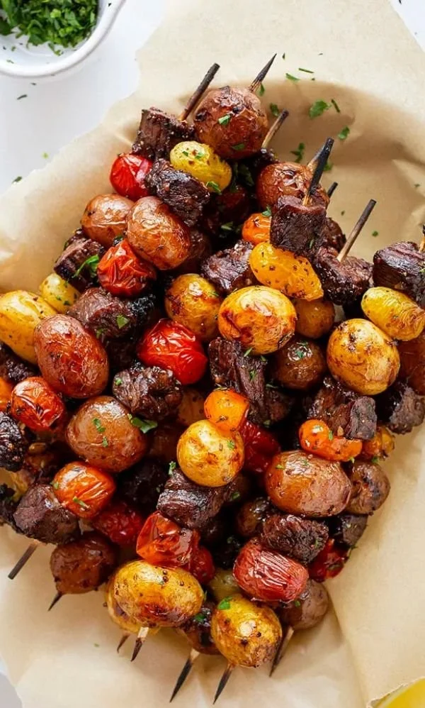 Delicious grilled steak kabobs on skewers with colorful veggies