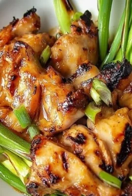 Vietnamese grilled chicken served on a plate with fresh herbs and spices