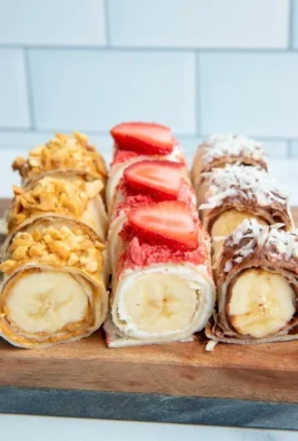 Tasty banana sushi rolls with fruit and nut toppings arranged on a plate.