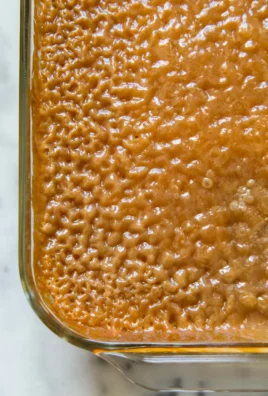 Biko Filipino sticky rice cake topped with coconut and brown sugar.