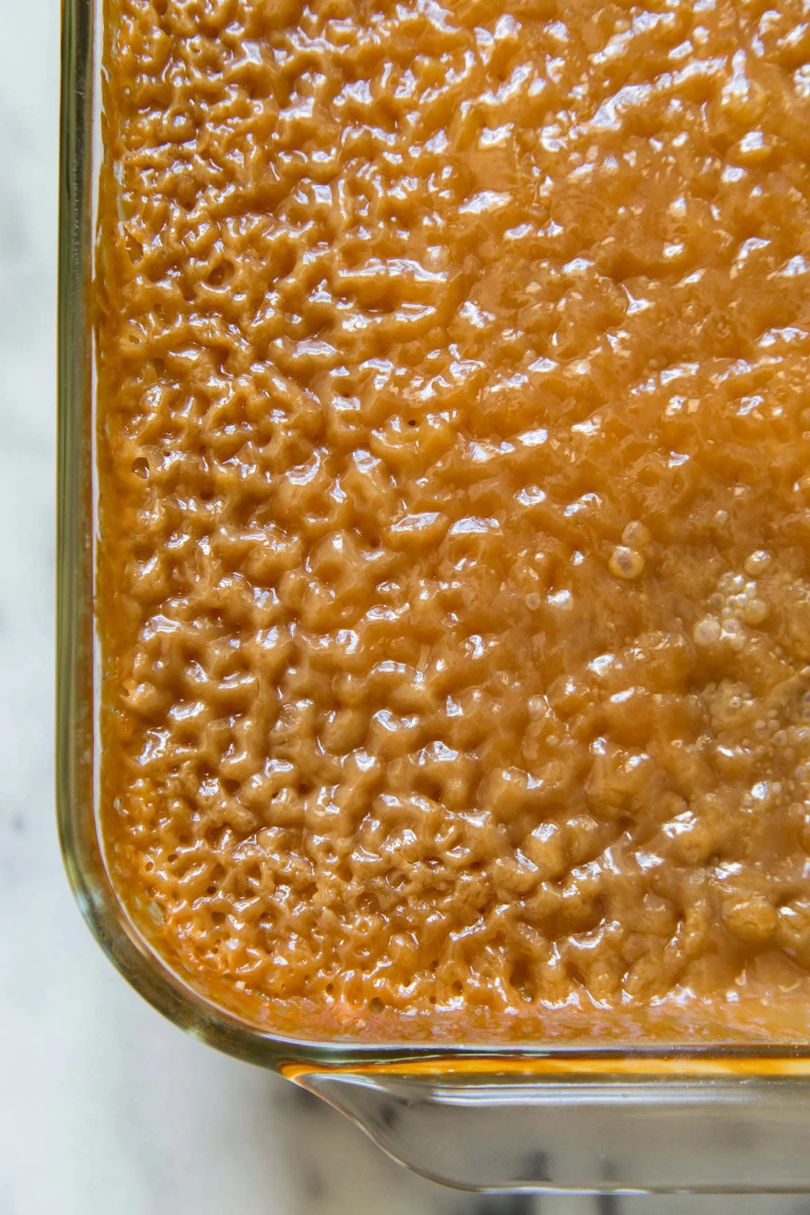 Biko Filipino sticky rice cake topped with coconut and brown sugar.