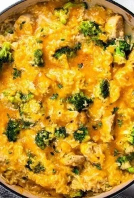 Cheesy Chicken and Rice Casserole served in a dish with colorful vegetables