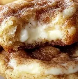 Delicious cinnamon roll cheesecake cookies on a plate, ready to be enjoyed.