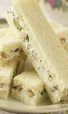 Cream cheese sandwiches with fresh ingredients and toppings on a plate