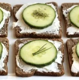 Delicious cucumber sandwiches served on a platter at a tea party.