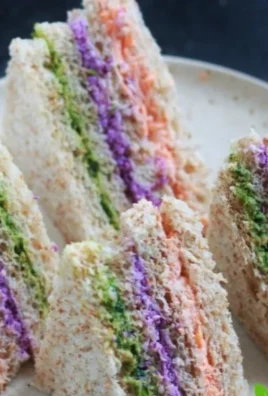 Colorful tea sandwiches arranged on a platter for a tea party or gathering
