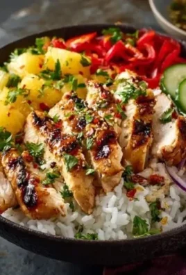 A vibrant Hawaiian Chicken Bowl with grilled chicken, rice, and tropical toppings.