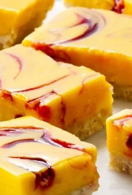 Delicious mango curd bars topped with fresh mango slices and a perfect creamy layer.