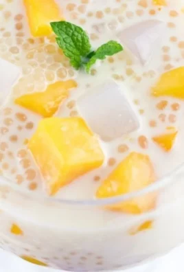 Delicious Mango Sago topped with Coconut Jelly in a bowl, a tropical dessert delight.