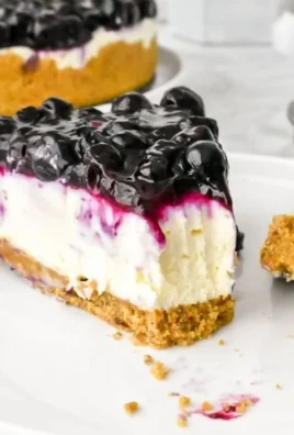 No bake blueberry cheesecake topped with fresh blueberries and cream