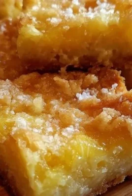 Delicious Pineapple Bliss Bars topped with coconut and pineapple slices