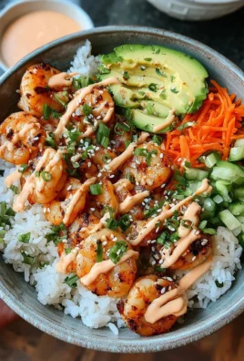 Shrimp rice bowl topped with spicy mayo and fresh vegetables