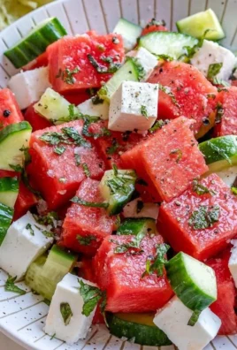 Fresh watermelon cucumber salad with feta cheese on a plate