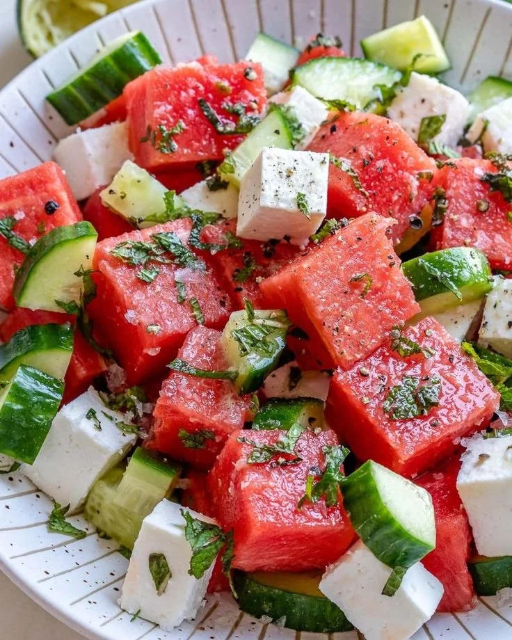 Fresh watermelon cucumber salad with feta cheese on a plate