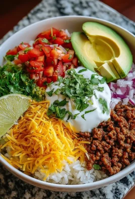 A colorful taco rice bowl topped with fresh ingredients and vibrant sauces.