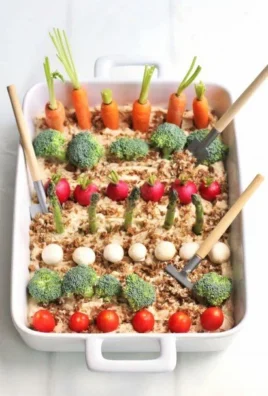 Colorful vegetable garden dip served with fresh veggies for snacking.