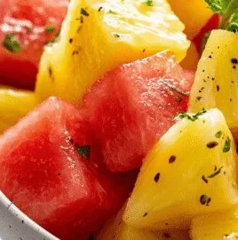 Refreshing watermelon and pineapple fruit salad served in a bowl.