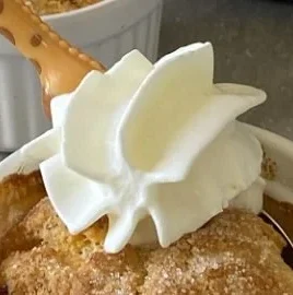Delicious air fryer peach cobbler served with vanilla ice cream
