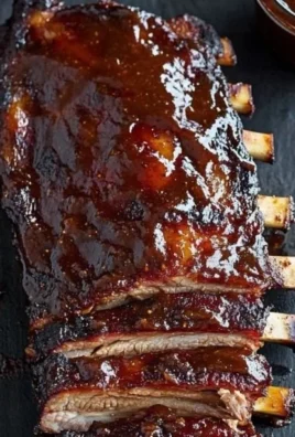 Delicious Apple Butter BBQ Ribs on a grill, ready to be served.