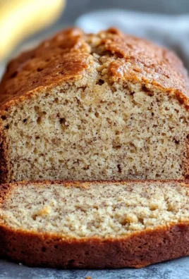Homemade banana bread sliced and served on a wooden board