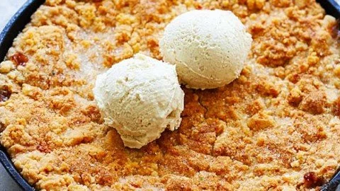 Bourbon Peach Cobbler dessert with fresh peaches and bourbon sauce.