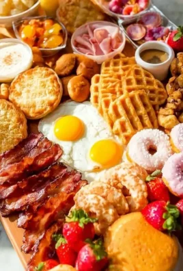 A beautifully arranged brunch platter with fruits, cheeses, and pastries.