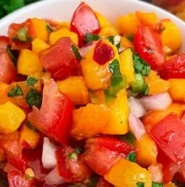 Bowl of easy homemade fresh peach salsa with colorful ingredients