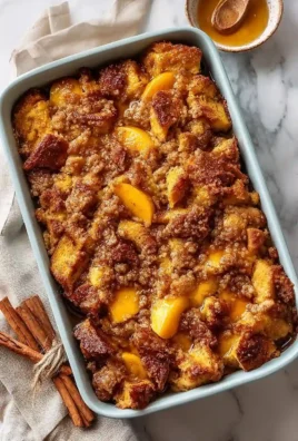 Easy Peach Cobbler French Toast Bake ready to serve with fresh peaches and syrup.