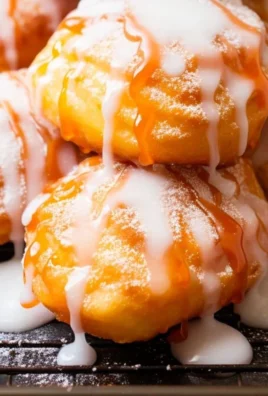 Homemade fresh peach fritters with a golden crispy exterior and peach filling
