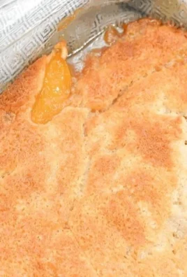 Delicious homemade Georgia peach cobbler served warm with ice cream
