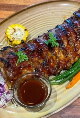 Delicious Grilled BBQ Baby Back Ribs ready to be served on a plate.
