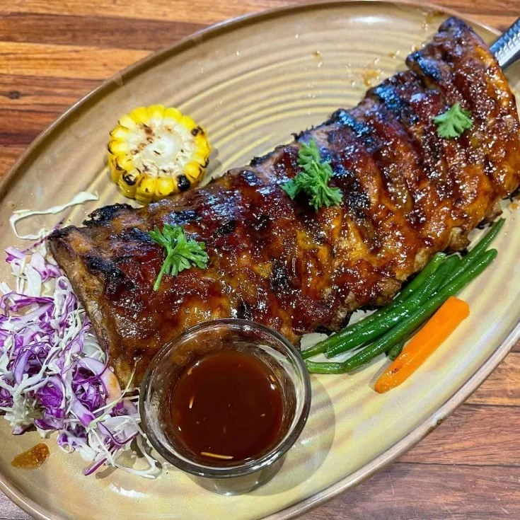 Delicious Grilled BBQ Baby Back Ribs ready to be served on a plate.