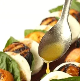 Grilled Peach Caprese Salad topped with Key Lime Vinaigrette served on a plate