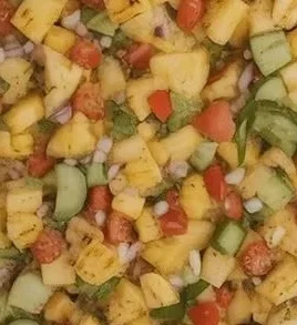 Delicious grilled pineapple salsa served in a bowl with fresh ingredients