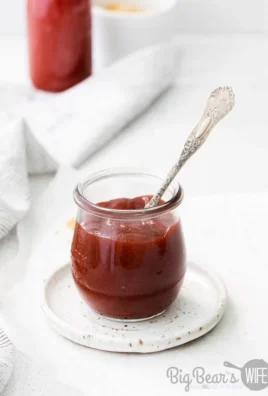 Homemade brown sugar BBQ sauce in a jar with fresh ingredients