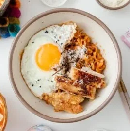 A plate of Homemade Fire Chicken Carbonara with spicy chicken and creamy sauce.