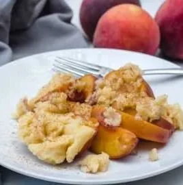 Delicious Instant Pot peach cobbler served in a bowl with ice cream.