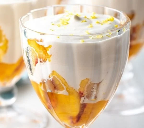 No-Bake Peaches and Cream dessert garnished with fresh peaches