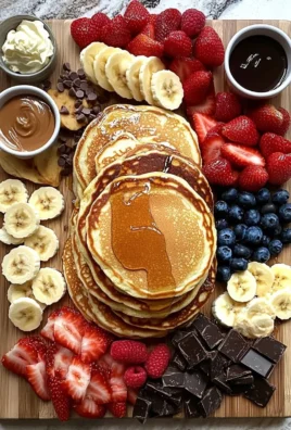 A beautifully arranged pancake board with toppings like fruits, syrup, and whipped cream.