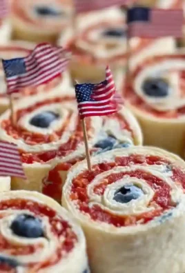 Patriotic cream cheese pinwheels arranged on a platter for a festive party.