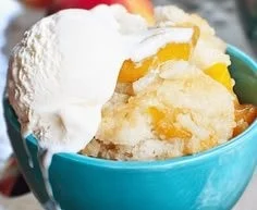 Delicious Paula Deen's Peach Cobbler served in a rustic dish
