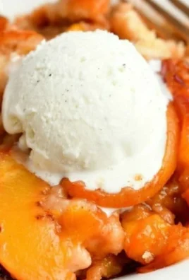 Delicious homemade Peach Cobbler served in a rustic dish with fresh peaches