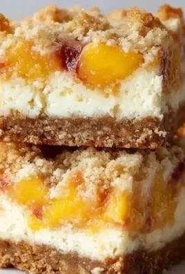 Delicious Peach Cobbler Cheesecake Bars topped with fresh peaches