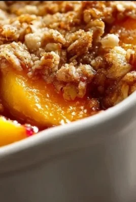 Delicious peach cobbler topped with a crunchy oatmeal layer, served fresh from the oven.