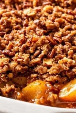 Delicious homemade Peach Crisp topped with oats and cinnamon served in a dish.